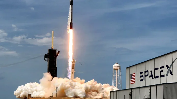Rocket launching into the sky, with flames and smoke visible at the base as it lifts off