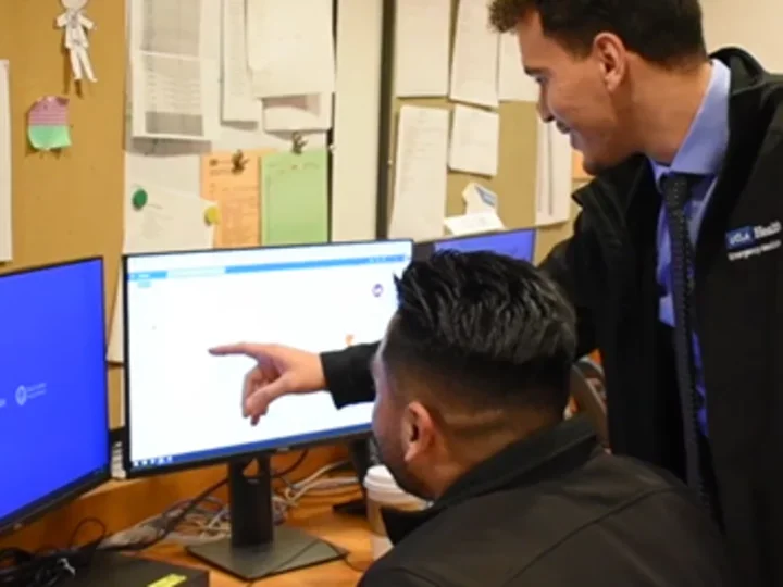 Man pointing at computer at New Member Training Committee