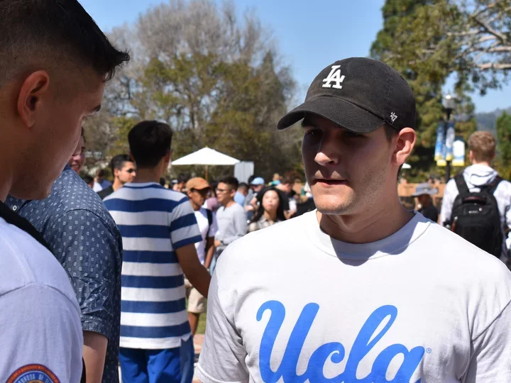 Man in UCLA shirt at outdoor event