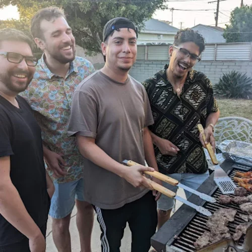 Drs. Calles (2022), Robinett (2025), Navarro (2025), and Dr. Grillmaster Hernandez (2025) grilling at an Intern Bootcamp welcome event for the class of 2027.